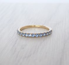 Here are our eternity stacking rings which have natural aquamarines set. Cut: Round Colour: light/med blue Size: 2.5mm diameter Clarity: VS1 (no visible chips or scratches) This ring measures 2.5mm wide and the height of the ring is 2mm, a perfect match to most wedding bands and engagement rings. We produce this ring in solid yellow, rose, white gold - 10k, 14k or 18k. **Please allow 3-4 weeks for production. We are unable to produce any faster than this. Aquamarine Eternity Ring, Aquamarine Ring Band, Aquamarine Wedding Band, Aquamarine Wedding, Blue Aquamarine Ring, Gold Stacking Ring, Ur Mom, Ring Wedding Band, Pave Band