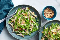 two plates filled with green vegetables and nuts