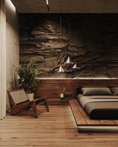 a bedroom with a stone wall and wooden flooring, along with a bed in the middle