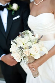 the bride and groom are holding their bouquets