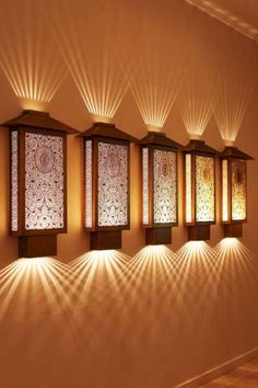 the lights are shining on the wall in the room with decorative panels and wood trimmings