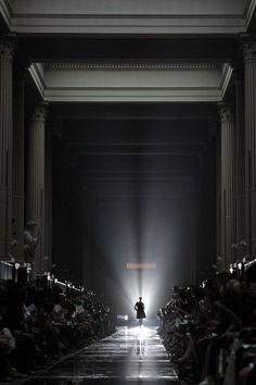 a person walking down a runway at night