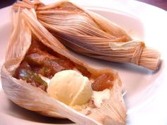 two tamales on a plate with ice cream