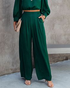 Relaxed Fit 100% Polyester Hand Wash Cold. Dry Flat High Rise Back Elastic Waistband Side Pockets Wide Pant Leg Satin Fabrication No Closures Not Lined Be the main character everywhere you go in this dark green colored set! Our Tamra Pocketed Satin Pants feature a smocked waist. These silky pants are designed with wide pant legs and a high rise. Styled with the Perfect Hoop Earrings. Find Your Way Compass Disc Necklace. Compass Coin Necklace. Stella Crossbody Envelope Zip Clutch. Simple Bangle B Green Wide Leg Set With Pockets, Green Wide Leg Workwear Sets, Green Wide Leg Sets With Pockets, Green Wide Leg Sets For Workwear, Be The Main Character, Silky Pants, Find Your Way, Green Fits, Satin Pants