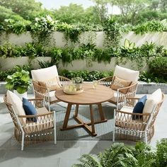 an outdoor table with four chairs around it