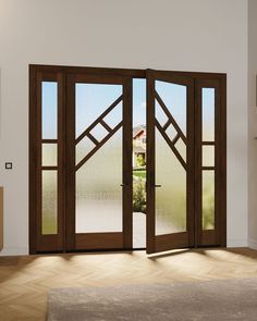 an open wooden door with glass panels in a room