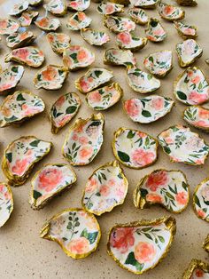 several pieces of porcelain with flowers on them sitting on a table next to each other