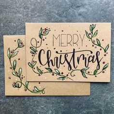 two christmas cards sitting on top of each other with the words merry christmas written in black ink