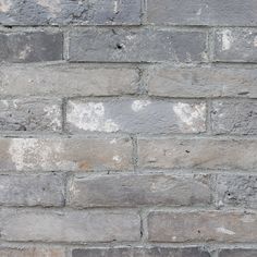 an old brick wall that has been painted gray