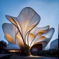 a large white sculpture sitting in the middle of a park