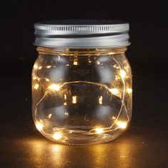 a jar with some lights in it sitting on a table next to the words 4 pack jar lights $ 10 00