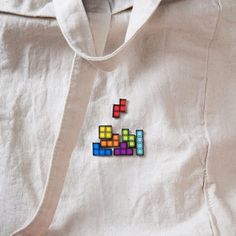 a white shirt with some colored blocks on it