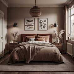 a large bed sitting under two pictures on the wall next to a window in a bedroom