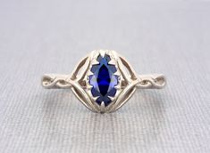 Sterling silver Celtic knot marquise blue sapphire engagement ring  Fusion blue sapphire size 10x5mm approx. marquise shape brilliant excellent cut solid sterling silver sapphire ring for women The ring dimensions are: front width: 12 mm/ 0.47" inch front height above the finger: 4.5mm/0.17" inch approx. side thickness: 1.7mm/0.06" inch side width: 3mm/0.11"inch back thickness: 1.4mm/0.05" inch back width: 2.4mm / 0.09" inch approx.   💎 OUR SHOP💎  https://www.etsy.com/shop/ClanTora 💍 RING 💍 Marquise Cut Sapphire Promise Ring, Gift Marquise Sapphire Ring, Marquise Sapphire Ring As Gift, Marquise Sapphire Promise Ring, Sapphire Promise Ring With Marquise Cut, Marquise White Gold Sapphire Ring, White Gold Marquise Sapphire Ring, Fine Jewelry Marquise Sapphire Promise Ring, Gift Marquise Diamond Cut Sapphire Ring