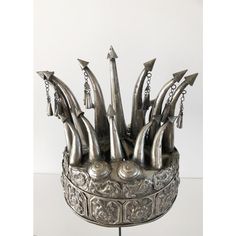 This exquisite vintage crown is a bridal headdress from the Chinese Miao Tribe. Decorated with hand crafted repousse fish and flower motifs. The dangling bells are a festive touch when the bride walks and dances as they make pleasant sounds with movement.    Mounted on a custom painted iron stand, it makes a spectacular display. This item is not "sterling silver", but it is a silver alloy that can be polished.   "Because the Miao silverware producing regions have no natural silver resources, the Bohemian Ceremonial Crown Headpiece, Traditional Ceremonial Headpieces For Festivals, Wedding Crown Headpiece For Festivals, Unique Wedding Crown Headpiece, Traditional Ceremonial Headpiece With Pinched Crown, Ceremonial Crown Headpiece For Festivals, Traditional Festival Headpiece With Structured Crown, Traditional Tall Crown Headpiece For Festivals, Traditional Headpiece With Structured Crown For Festivals