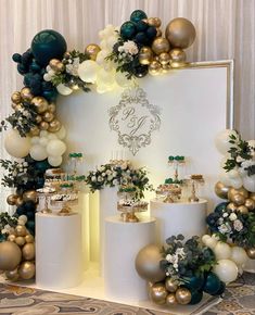 a table topped with lots of white and gold balloons