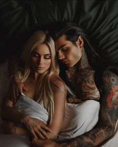 two beautiful young women sitting next to each other on top of a white bed covered in tattoos