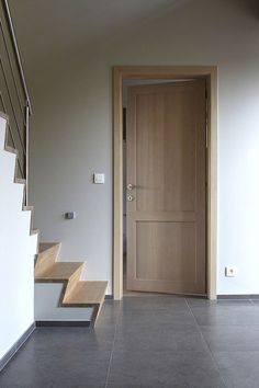 an open door and some stairs in a room