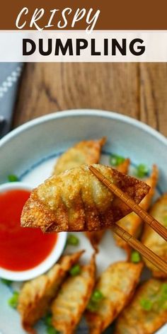 some fried dumplings on a plate with chopsticks and ketchup in the bowl