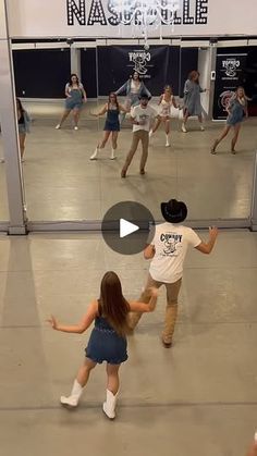 several people are dancing in a dance studio