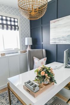 a living room with a white table and blue walls