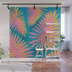 a wall mural with pink and blue leaves on it in a living room next to a wooden floor