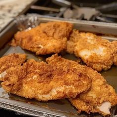 three fried chicken pieces on a pan ready to be cooked