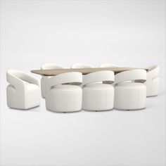 a group of white chairs sitting next to each other on top of a wooden table