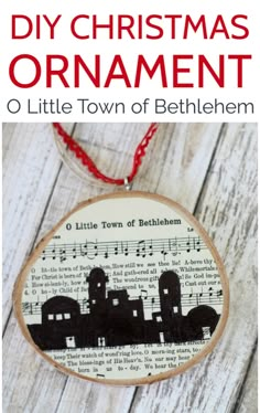 a christmas ornament made out of an old book page with the words, little town of bethlemem on it