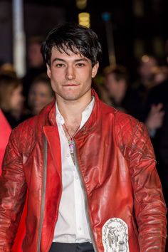 a man wearing a red leather jacket and white shirt