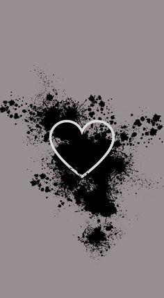 a black and white heart with splats on the ground in front of it