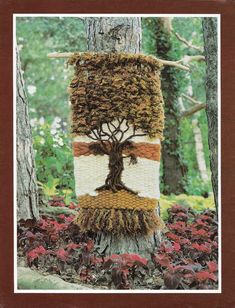 a knitted tree is shown in the woods