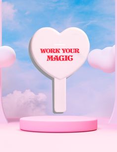 a heart shaped lollipop with the words work your magic on it