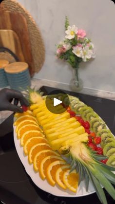 a plate with sliced up fruit on it and someone placing them in the trays