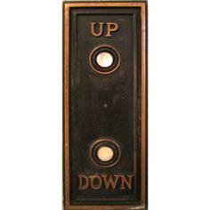 an up down sign mounted to the side of a wall