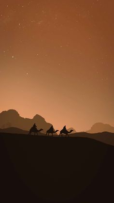 three people riding camels across a desert under a night sky with mountains in the background