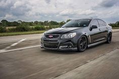 the chevrolet ssv is driving down the road with cloudy skies in the back ground