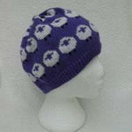 a knitted beanie hat with sheeps on it