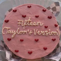 a pink cake with hearts on it that says fifteen taylor's version