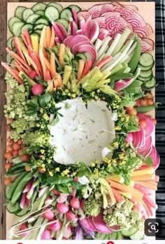 an arrangement of vegetables arranged on a cutting board