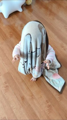 a baby in a hand puppet on the floor