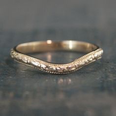 a close up view of an antique wedding band