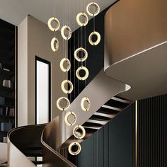 a spiral staircase with circular lights hanging from it