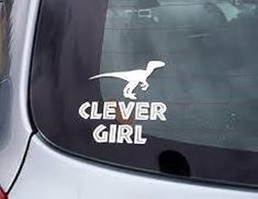 a sticker on the side of a car that says clever girl with a dinosaur