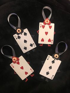 four playing cards that have been made to look like hearts