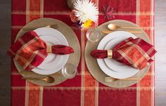 a place setting with red and gold napkins