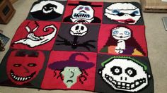 a crocheted blanket with many different faces on it, including skulls and witches