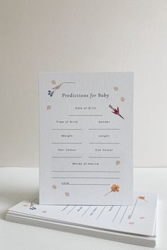 a card with the words, congratulations for baby written on it next to an envelope