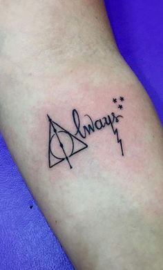 a harry potter tattoo with the word always written in cursive writing on it