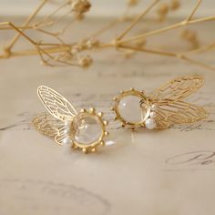 Experience the magic with our fairy wing earrings. Made from 18K gold with butterfly wing designs, these unique pieces add a whimsical touch to any outfit. Perfect for those who love fantasy-inspired jewelry. Transform your look with our fantasy inspired jewelry. Crafted from luxurious 18K gold, these earrings blend elegance and whimsy. Ideal for those seeking cute and unique accessories. Embrace ethereal elegance with our butterfly wing earrings. These 18K gold pieces feature a delicate design, perfect for adding a touch of fantasy to your style. ** Jewelry Care Guide ** Please keep it away from chemicals, store it in a dry place, avoid dropping, and seal it when not in use.  Alloy: Avoid contact with water.  18K gold and 925 silver: Clean regularly with a silver cloth.  Natural pearls: A Gold Fantasy Jewelry, Elegant Winged Earrings For Gift, Fantasy Winged Jewelry Gift, Whimsical Gold Jewelry For Pierced Ears, Pierced Winged Earrings As Gift, Handmade Winged Earrings For Gifts, Gold Fairycore Drop Earrings, Fairycore Earrings For Pierced Ears As A Gift, Fairycore Jewelry With Matching Earrings For Gift